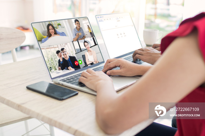 Work at home and social distancing concept, woman talking to her colleagues about plan in video conference in house, meeting and planning online as covid 19 or corona virus disease