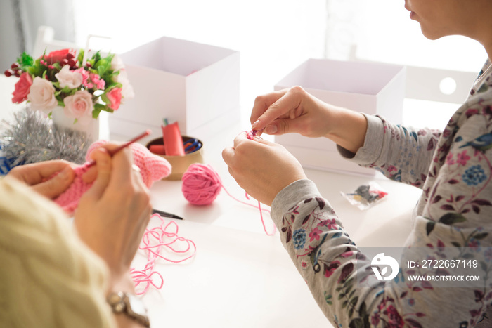 Young attractive girls in a crochet lesson