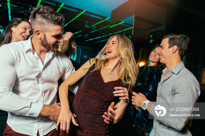 Group of friends partying in a nightclub