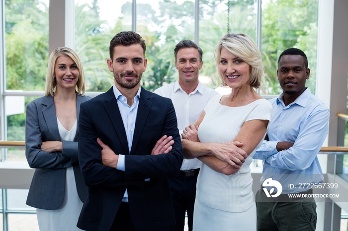 Business executives with arms crossed at conference center