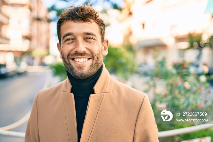 Handsome business man wearing elegant jacket smiling happy outdoors