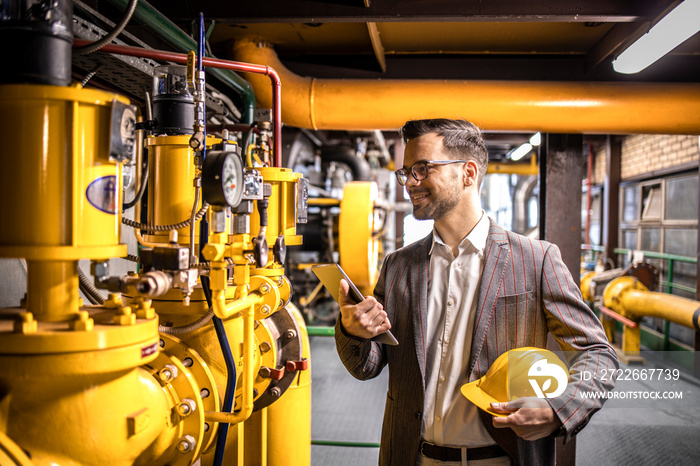 Refinery manager checking production and results in power plant.