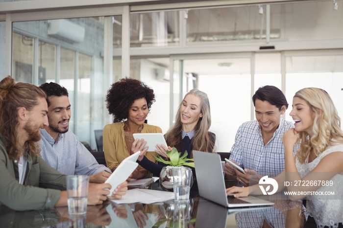 Happy business people working together at desk