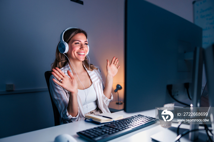 Woman having conference call while working late