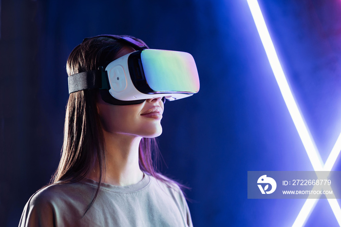 Young woman using virtual reality headset, VR, future, gadgets, technology, education online, studying, video game concept. Closeup portrait of beautiful girl wearing vr glasses.