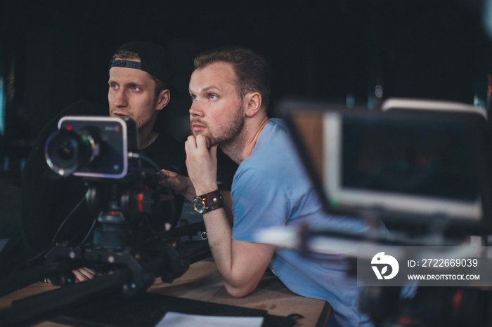 Director of photography with a camera in his hands on the set. Professional videographer at work on filming a movie