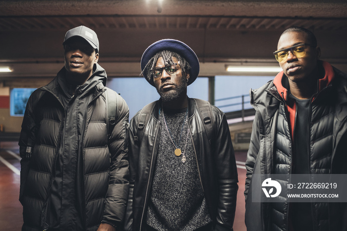 portrait of young african men posing in the street and looking camera