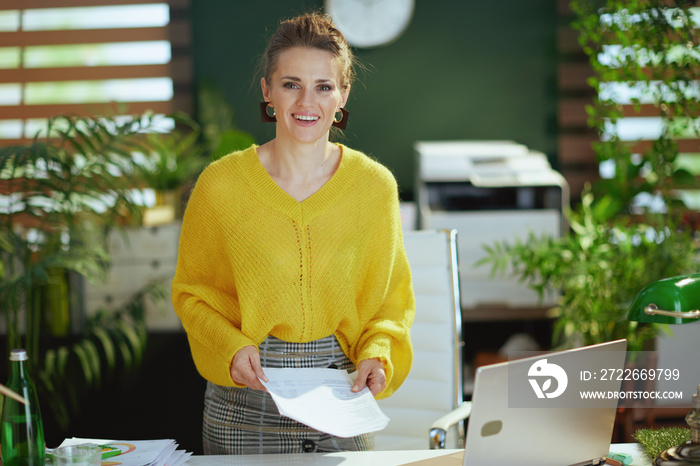 business owner woman in green office working with documents