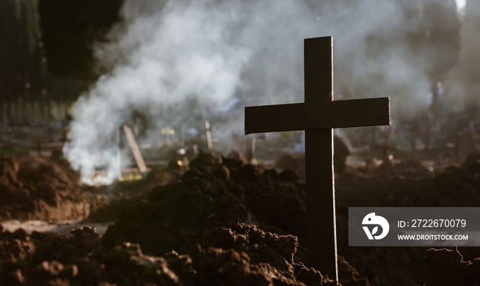 Cross, fire and death. After digging and removing the human rests of the graves, it seems a war landscape.