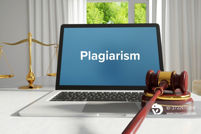 Plagiarism – Law, Judgment, Web. Laptop in the office with term on the screen. Hammer, Libra, Lawyer.