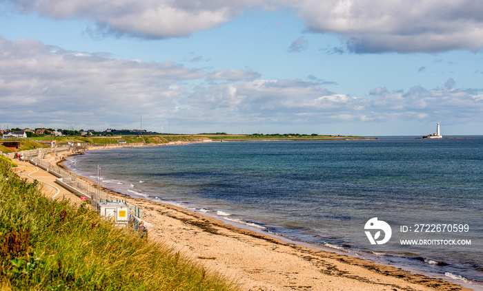 Whitley Bay beach and a lighthouse in a background in a summer day, England