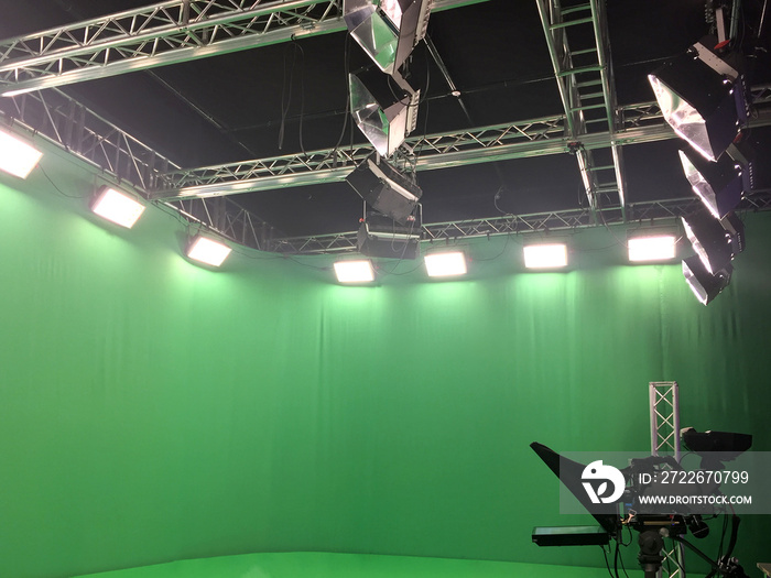 Modern empty green video recording and broadcasting studio with tv channel led screen and metalic stands, lights on