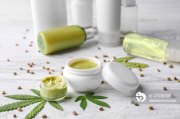 Cosmetics with hemp extract on white wooden background