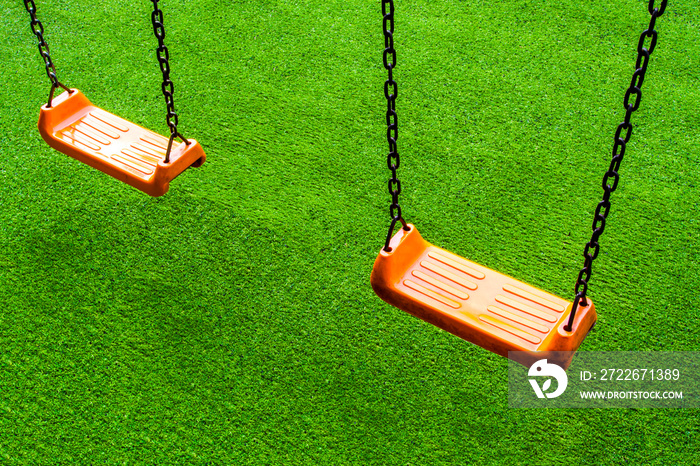 Swing seat on the artificial grass playground