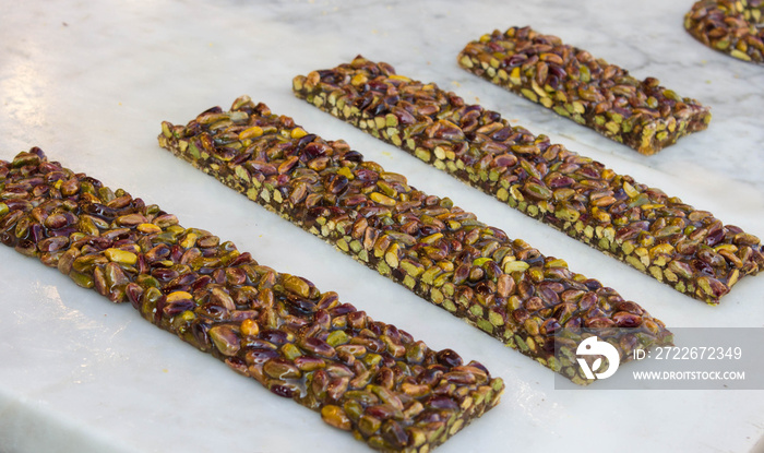 Pistachio nut sweet bars on the stone table, Mediterranean sweets.