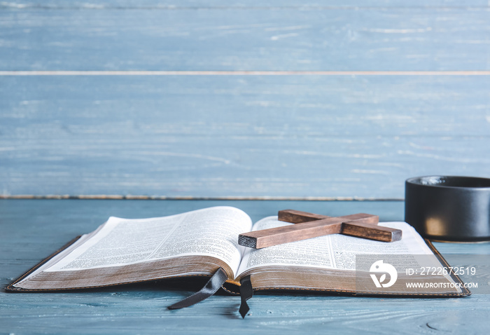 Holy Bible, cross and cup of coffee on table