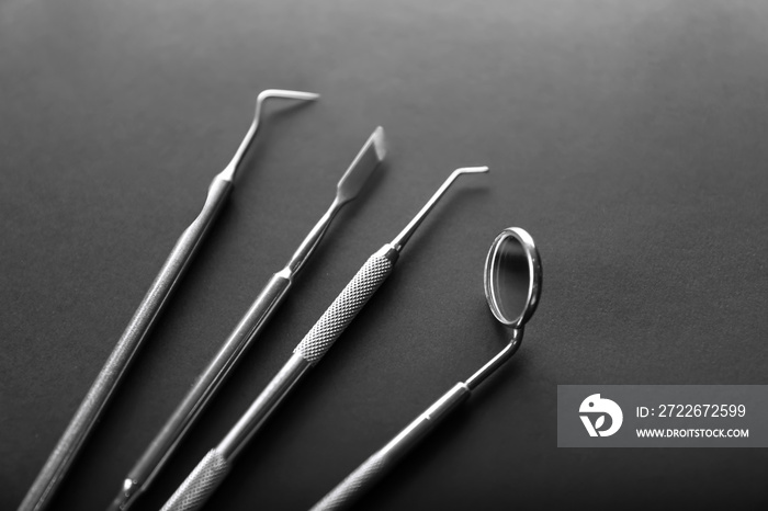 Dentist’s tools on dark background