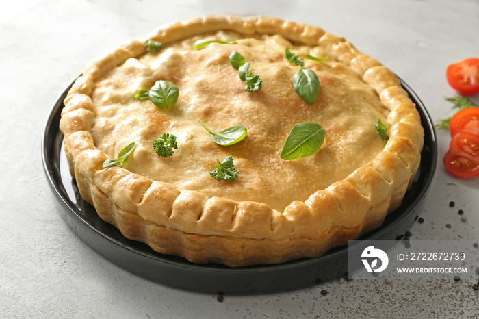 Baking dish with turkey pot pie on light background