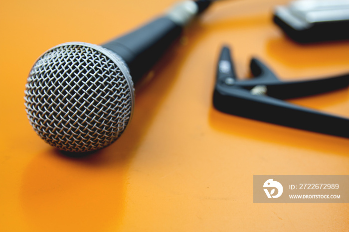 The microphone on the table wooden yellow.