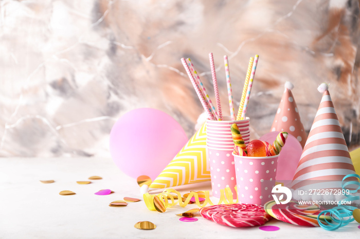 Birthday party items with candies on table