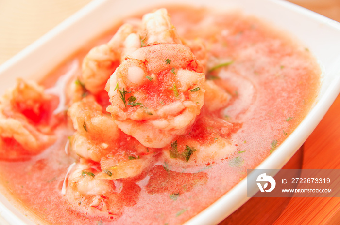 Close up of selective focus in a delicious shrimps of Ecuadorian food: shrimp cebiche in a blurred background