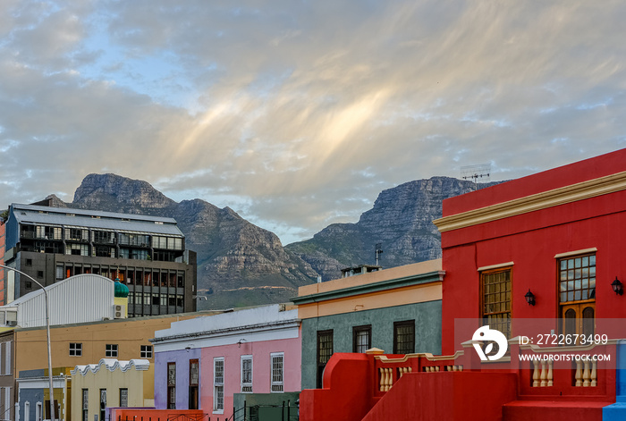 Bo Kaap, Cape Town, South Africa, with the table mountain in the background, colorful outdoor street and city photo of buildings during sunset