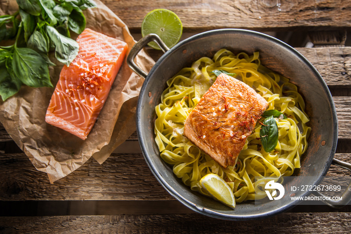 Pieces of roasted salmon with pasta tagliatelle lemon and basil