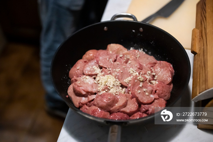 Chef Preparing Bull Balls or Testicles on a Kitchen Board