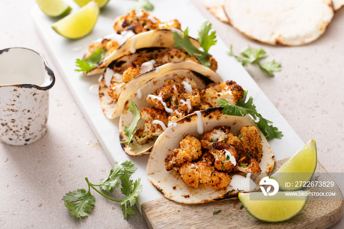 Spicy cauliflower tacos with cilantro and mexican crema