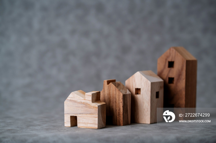 many toy wooden house block on grey leather background