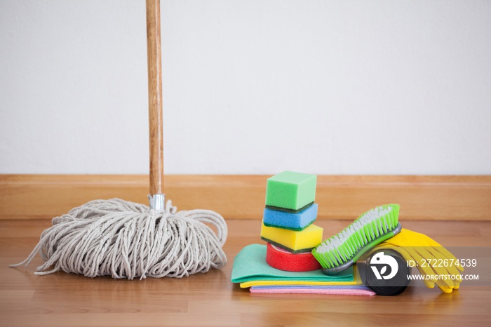 Mop and cleaning equipment on wooden floor