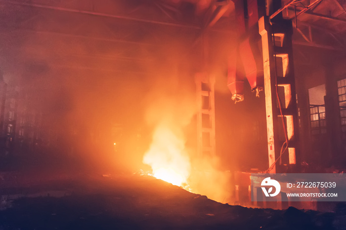 Burning large industrial warehouse hall. Fire inside factory interior