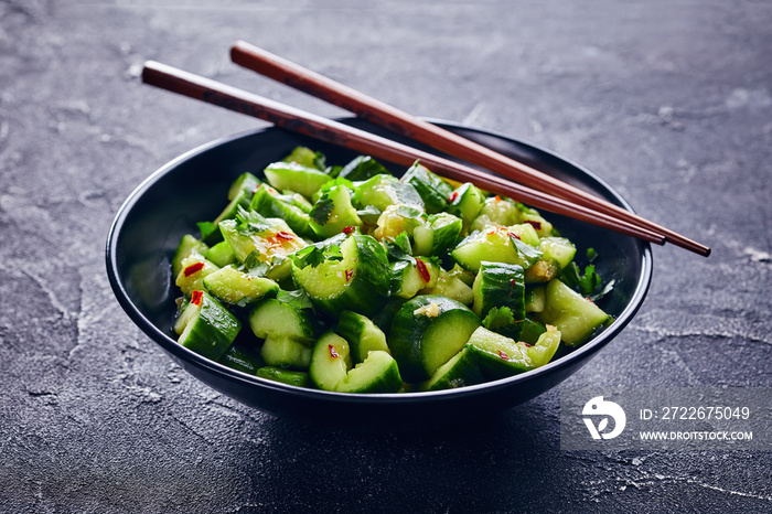 Chinese Smashed Cucumber salad in a black bowl