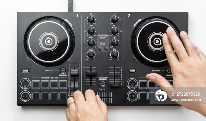 Dj Hands is scratching and mixing Digital Dj deck Controller, Topview, isolated on white.