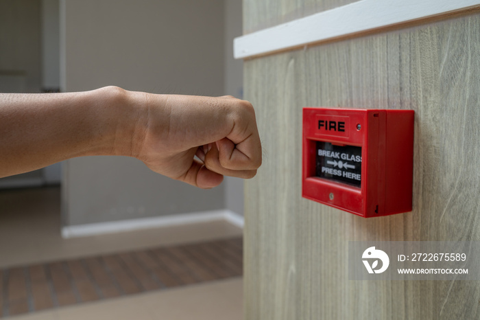 Fire alarm box with human hand action to crush the glass for emergency situation.