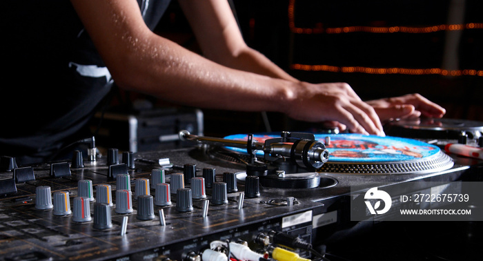 turntable, hand of dj on the vinyl record