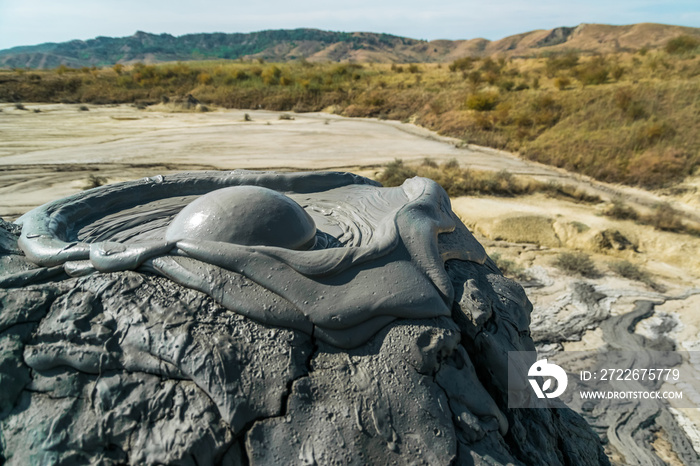 Active mud volcano eruption with a mud bubble captured in Romania