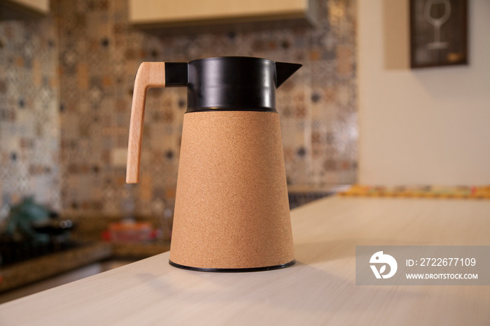 Coffee thermos bottle with cup, placed on the counter of a Brazilian kitchen. Kitchen as a background. Coffee concept. Brazil concept.