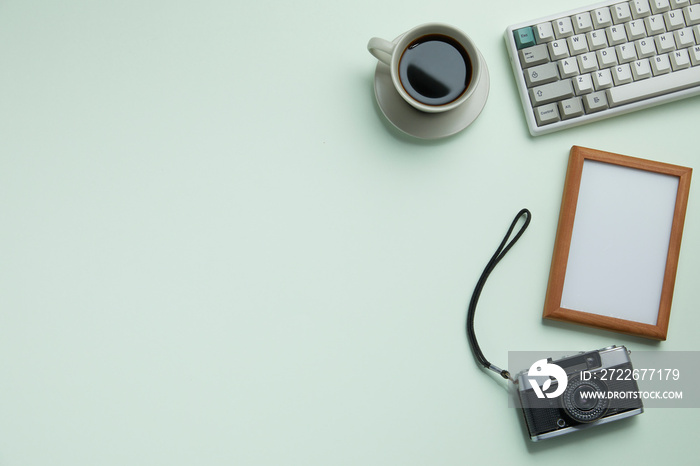 top view of pastel green desk with office stationary. copy space