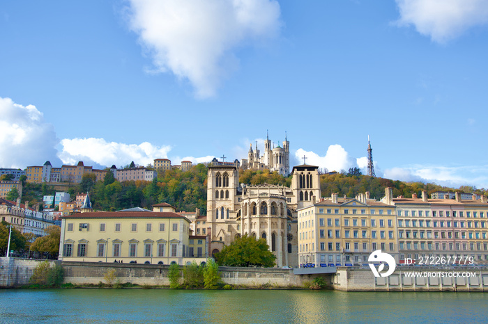 Autumn in Lyon with the Saône river and the saint jean cathedral in the foreground and behind our lady of fourviere basilica at the top of the hill.