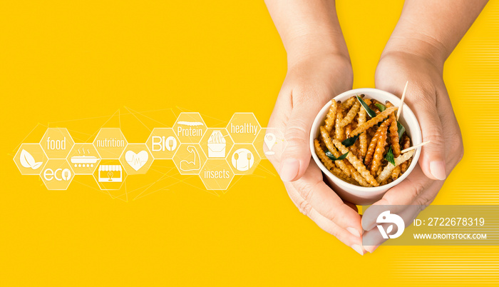 Bamboo worm for eating as food insects in disposable cup on woman’s hand and icon nutrition media. Bamboo Caterpillar snack deep-fried for take-away is good source of protein edible. Entomophagy.