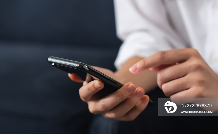 Hand holding smartphone with using social media on internet.