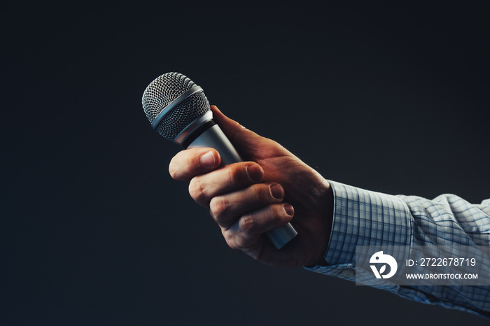 Hand with microphone doing an interview for the media