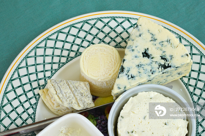 A gourmet cheese platter with ripened goat cheese and blue cheese