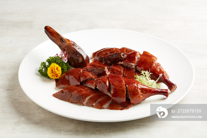 Osmanthus-infused Crispy Roasted Duck served in a dish isolated on grey background