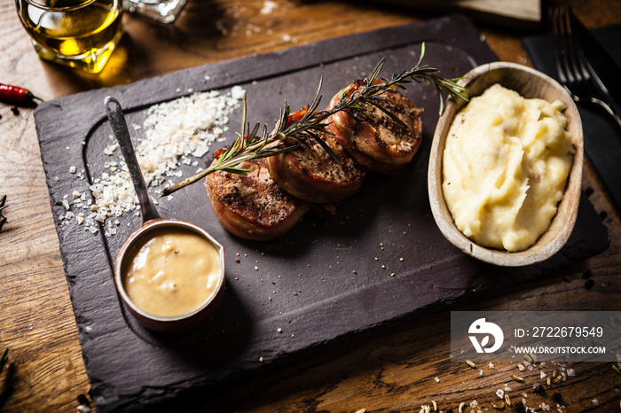 Pork tenderloin served on a board in restaurant