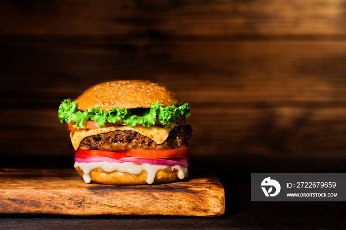 Close-up of delicious homemade burgers on a wooden table on a dark background beef hamburger freshly cooked delicious