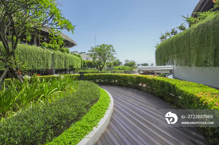 Sky garden on private rooftop of condominium or hotel, high rise architecture building with tree, grass field, and blue sky. Environmental friendly and eco-friendly concept.