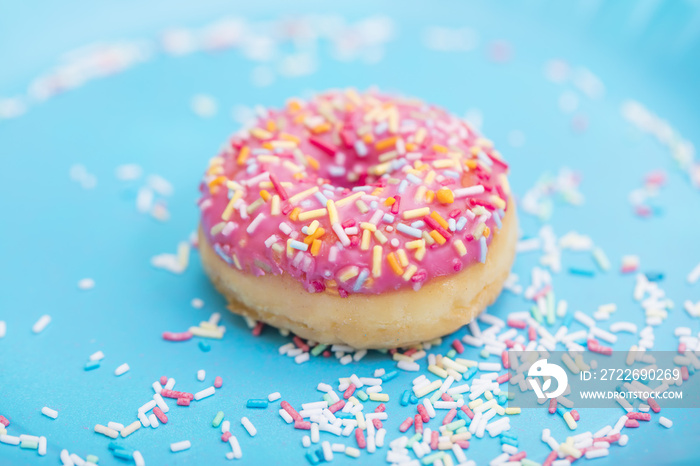 Pink donuts with sprinkles on blue background