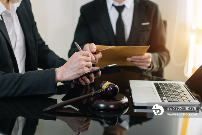 Business and lawyers discussing contract papers with brass scale on desk. Law, legal services, advice,  justice and law concept ..